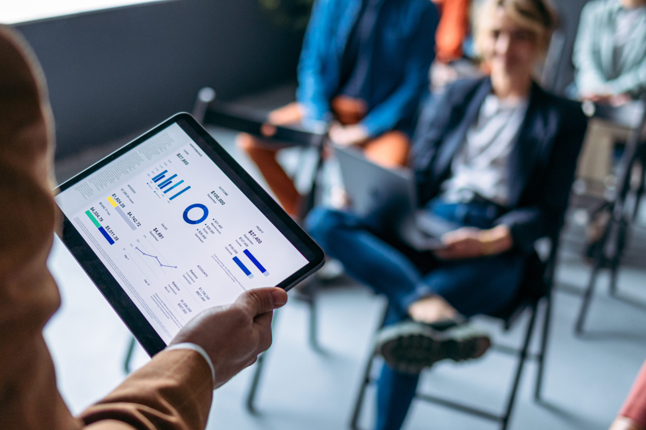 Unrecognizable Presenter Holding A Digital Tablet With Business Graph On An Education Event